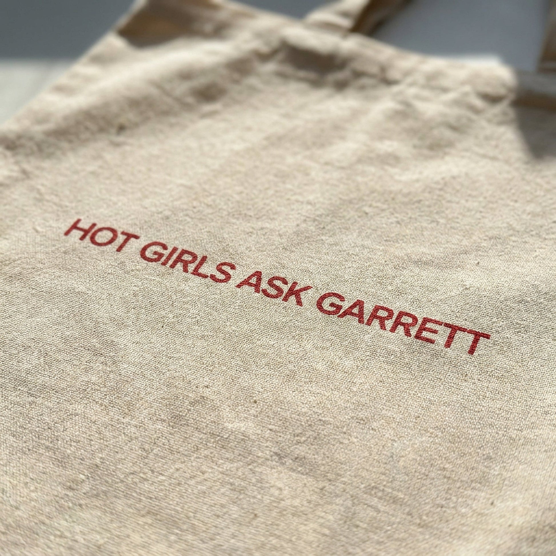 Close-up of the Hot Girls Ask Garrett slogan print on the cotton tote