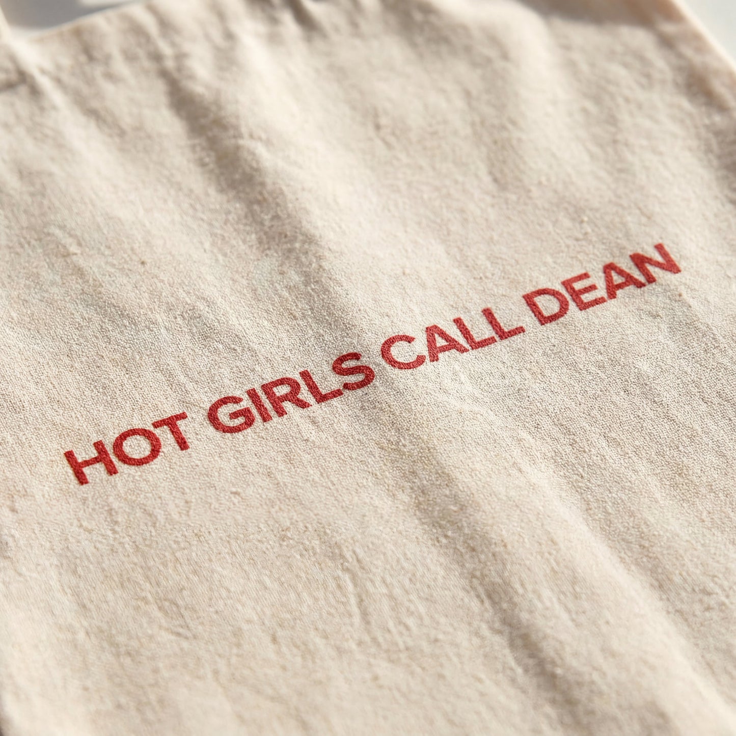 Close-up of the Hot Girls Call Dean slogan print on the cotton tote