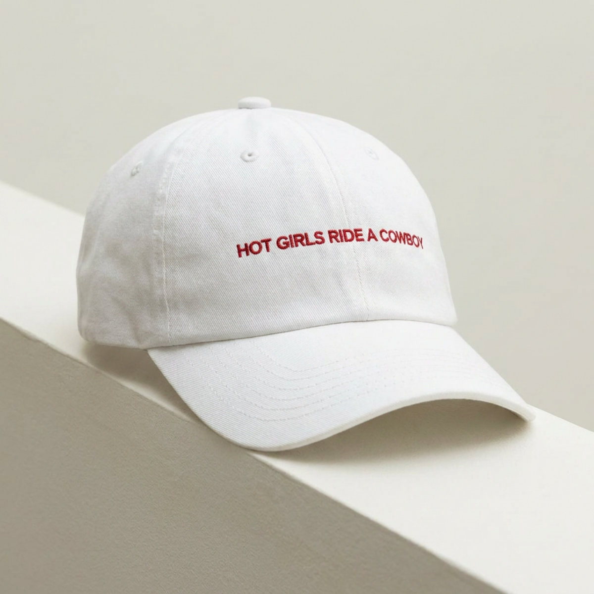 Hot Girls Ride a Cowboy embroidered dad cap photographed against a wall