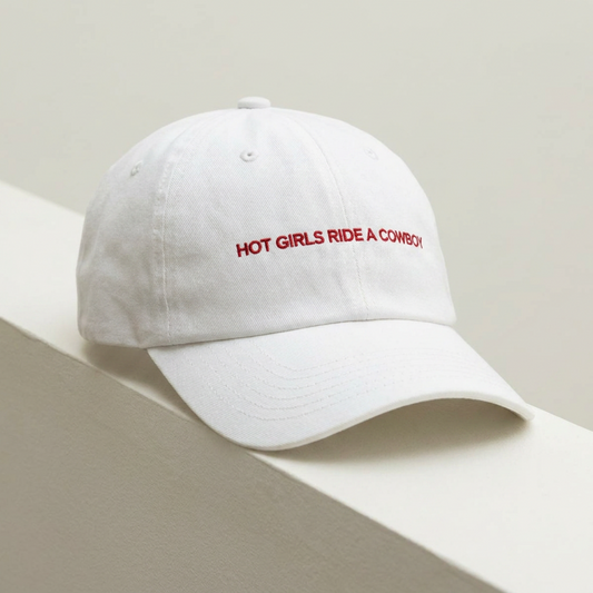 Hot Girls Ride a Cowboy embroidered dad cap photographed against a wall