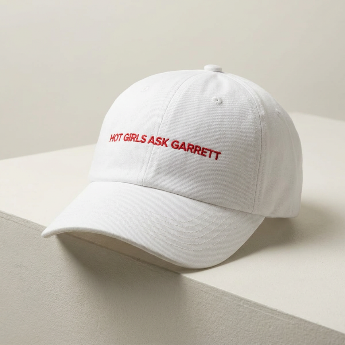 Hot Girls Ask Garrett embroidered dad cap photographed against a wall