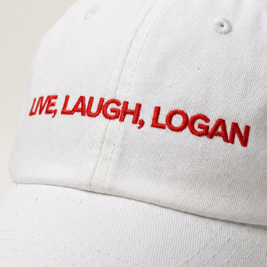 Close-up of the Live, Laugh, Logan embroidered slogan on a dad cap