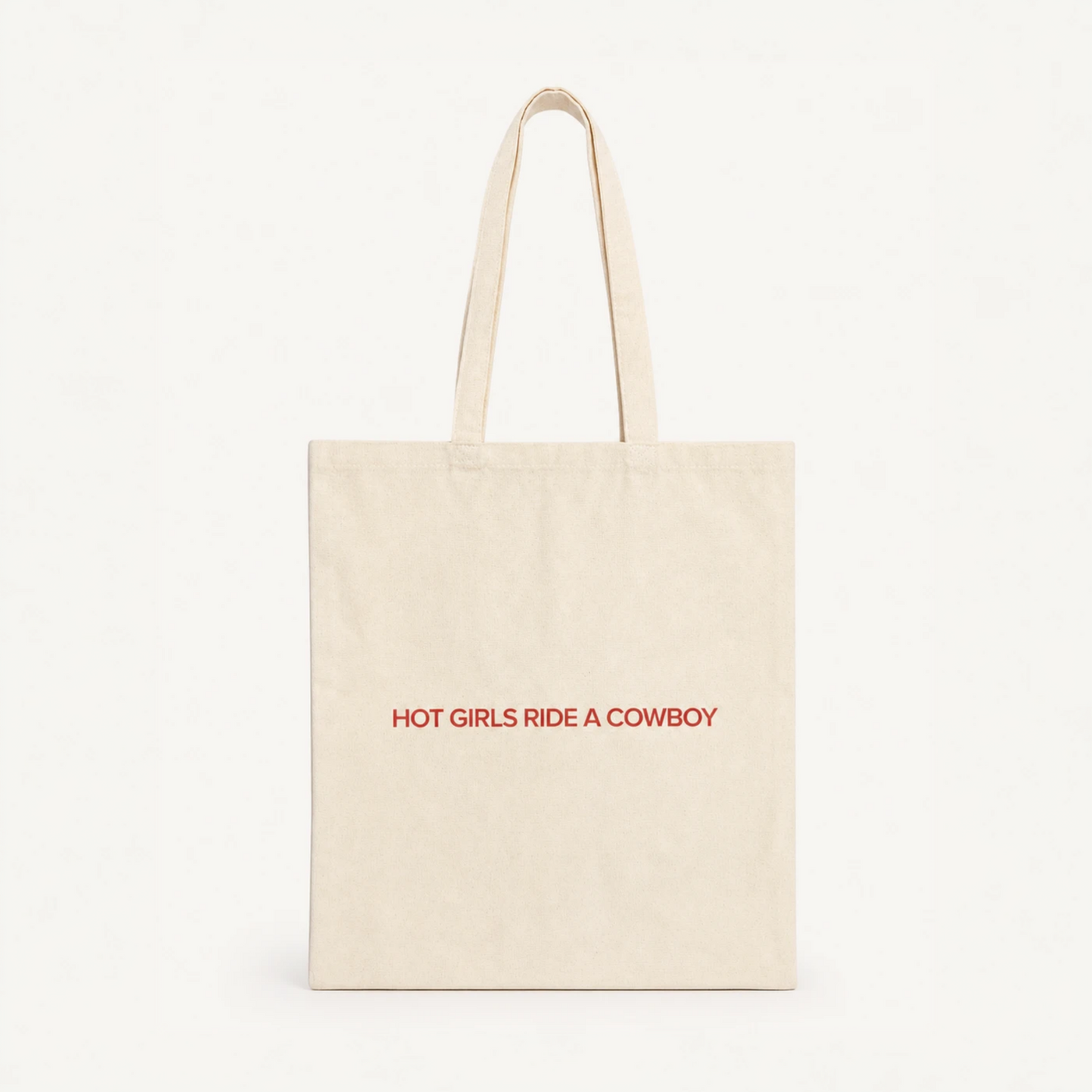 Hot Girls Ride a Cowboy natural cotton tote bag in brand red, cowboy romance merch by After Hours Book Club